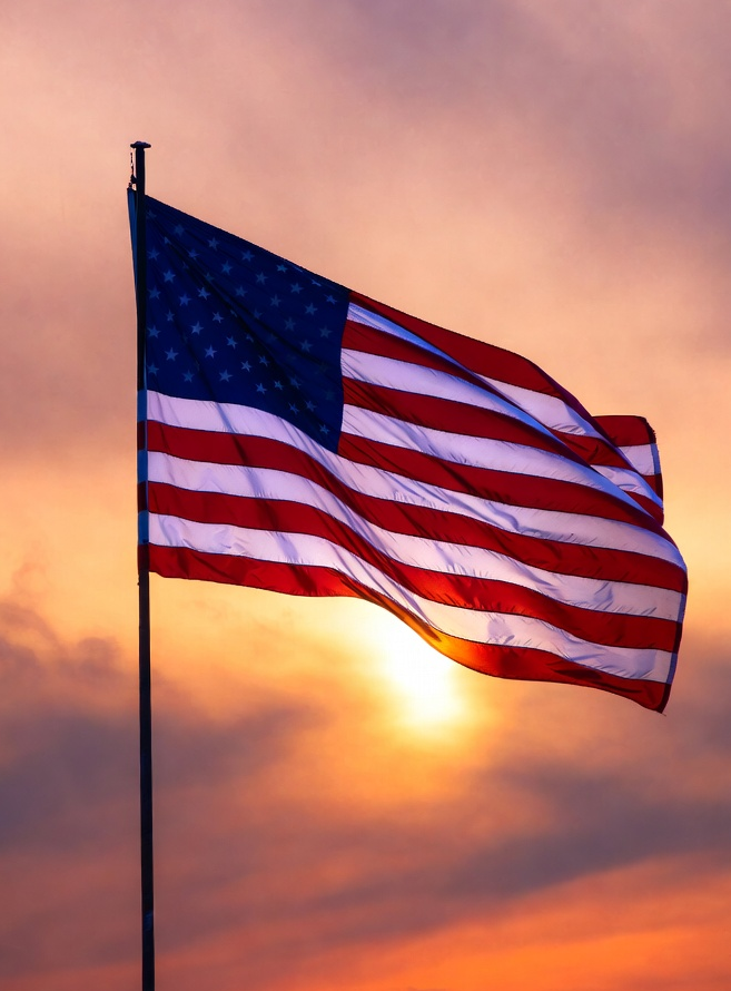 Flying US Flag against sunrise light